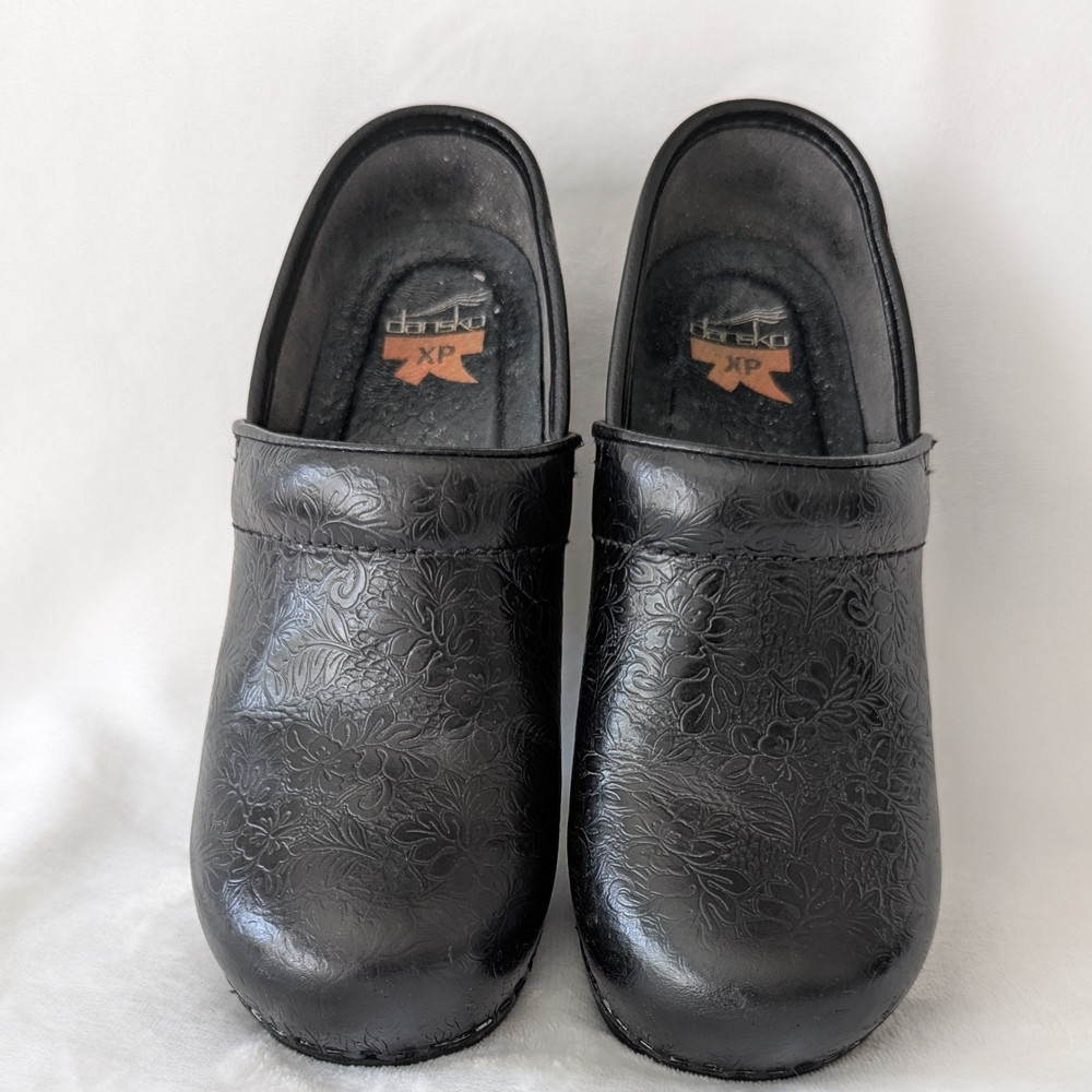 Dansko Black Embossed Floral Clogs